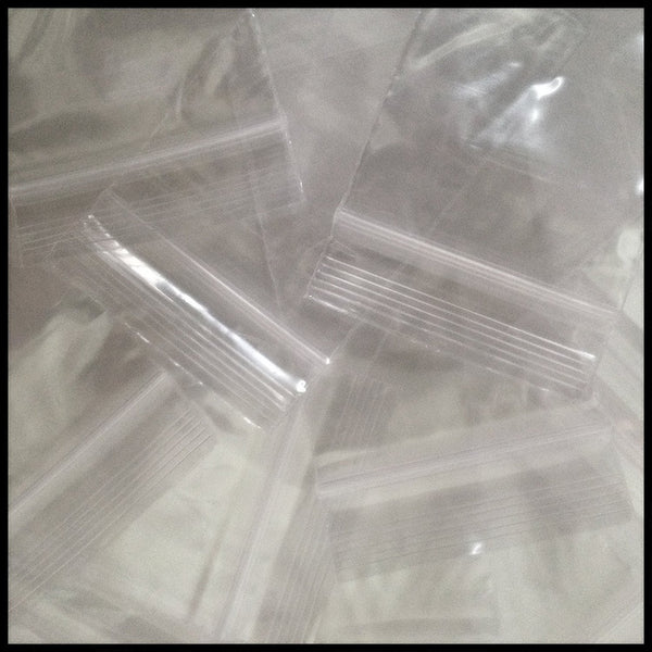 Clear 2x3 inch resealable plastic bags by Original Apple Bags, 4 mil thick, durable reclosable storage solution.